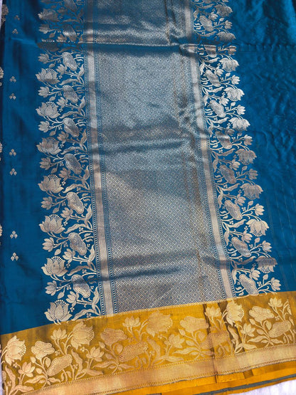 Peacock Blue Mashru Silk Saree with Mustard Contrast Floral Border and Silver-Gold Buta
